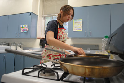During her independent cooking class, Wilkinson experiments and perfects her cooking techniques while preparing to fry her homemade potstickers.