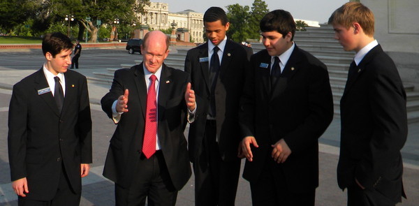 On the way to a Democratic Senatorial Campaign Committee event, senior Jimmy Loomis and three other pages walks alongside Senator Christopher Coons, a Democrat from Delaware. The page program allowed first-hand interaction with Senators and other national leaders who exert a powerful influence on politics.
