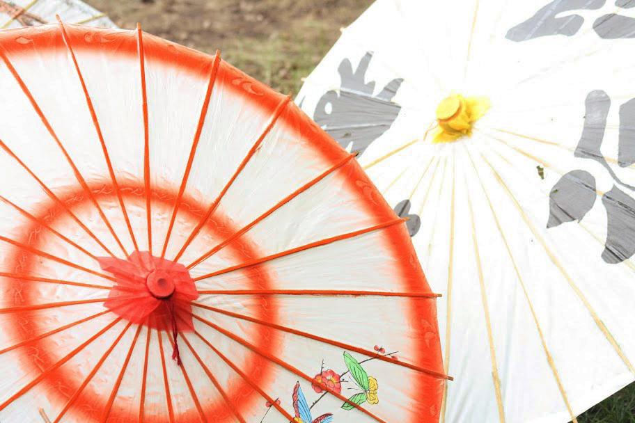 At the Japanese Festival, colorful Japanese parasols are offered beside other Japanese products. Visitors have the chance to purchase a number of Japanese good, including kimonos, various types of candy, and stuffed animals.