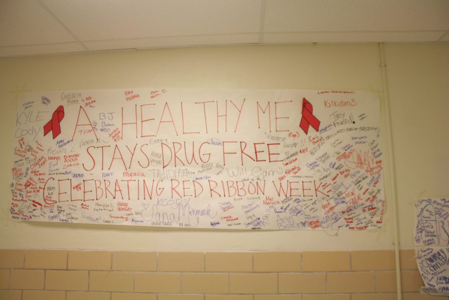Ladue students sign their names on a poster after taking a pledge that promotes being drug free.   