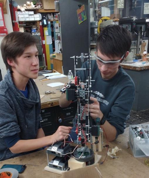 Patrick Naughton and Luke Biernbaum work on their robotic arm.