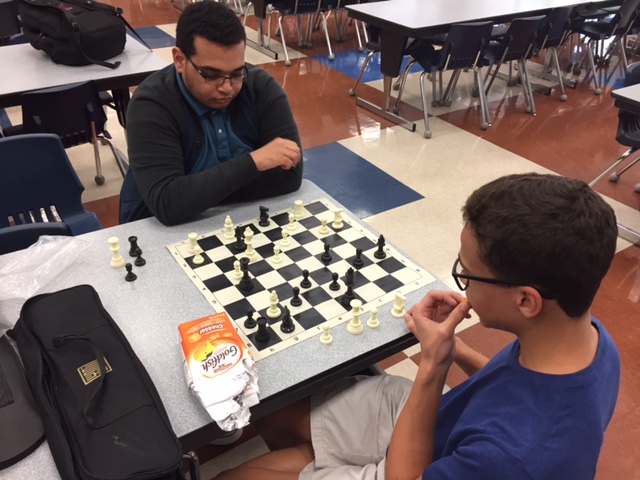 Pondering their next moves, sophomores Jacob Griggs (left) and Julian Carroll (right) take each other on in the high school cafeteria during a chess practice Sept. 20.
