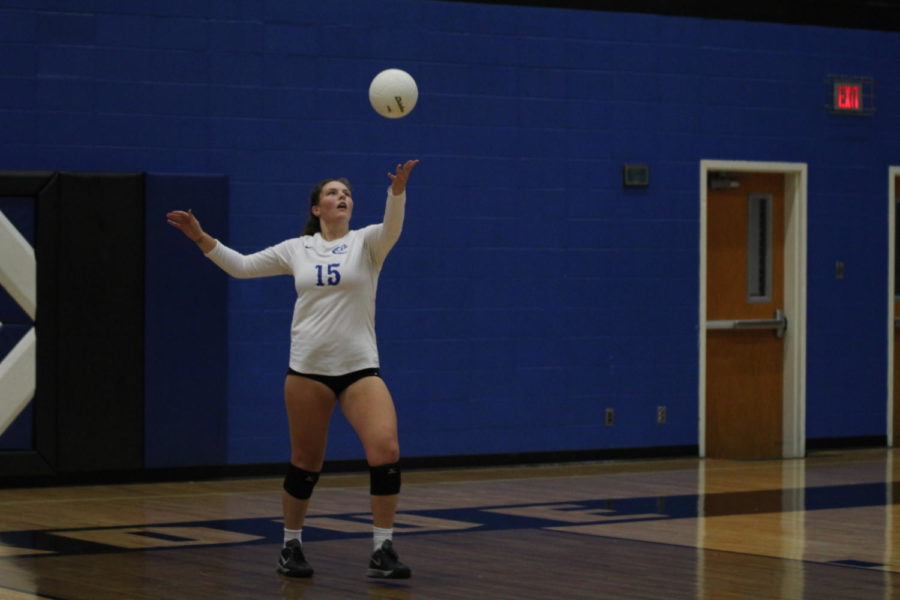 Senior Olivia Schroder serves the ball.
