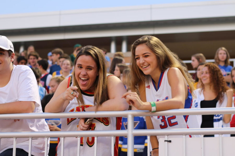 Sophmores Katherine Lucier and Lizzy Feinberg cheer on the football team from the stands.