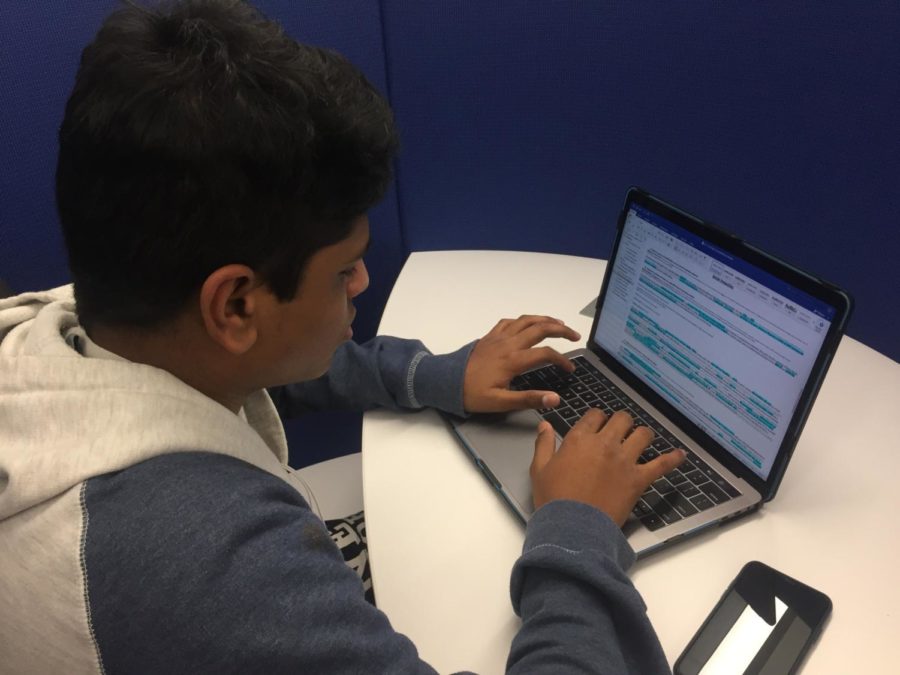 Sophomore Phani Chintakunta revises his debate case in the library while waiting for first hour to start. Together with his partner, Junior Max Kornfeld, Chintakunta won the Championship division of policy debate at the Jefferson City Capitol Classic on January 27 with a unanimous panel of judges. "It felt really rewarding to win." Chintakunta said.