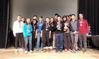 Ladue’s Science Olympiad team stand on a stage after the Awards Ceremony. 15 people competed at an invitational in the University of Chicago. (Photo courtesy of Mark Biernbaum)