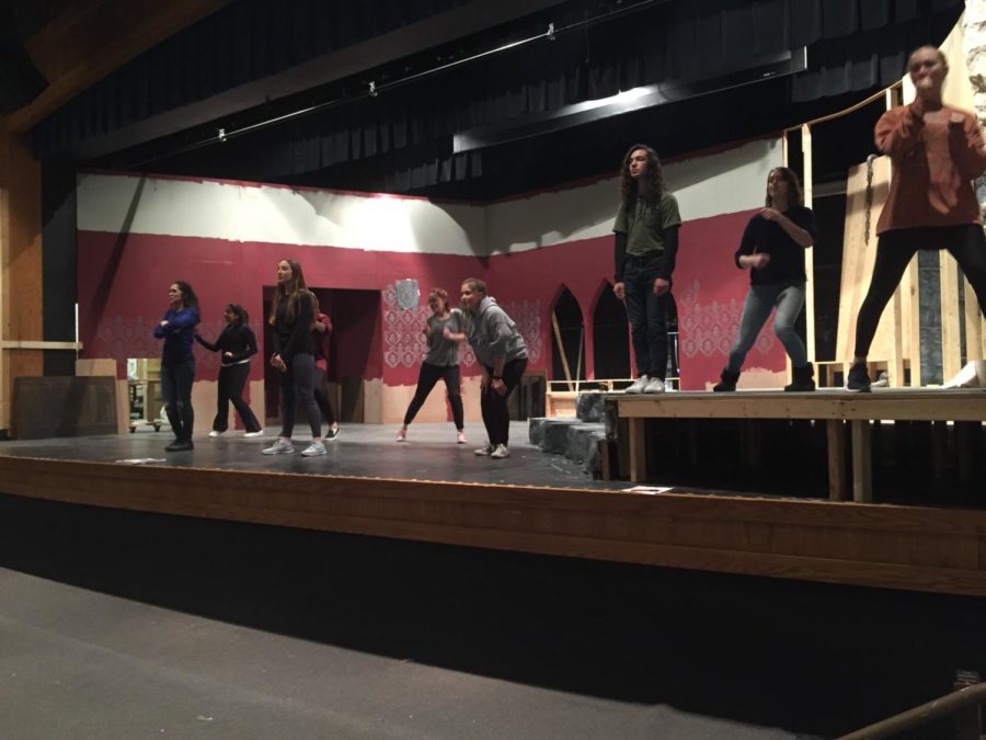 Getting ready to hit the stage, the cast of The Addams Family sings on the newly-built set. They open Feb. 22. There are no deadline extensions or extra help we can get, all of us have to work really hard to get the show where it needs to be, but thats what makes it exciting, senior Katie Bohnert said.