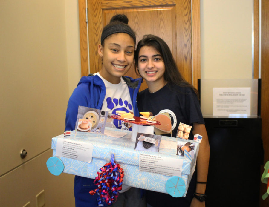 Sophomores Sarah Nselel and Callie Cox show off their shoebox Feb. 13. 