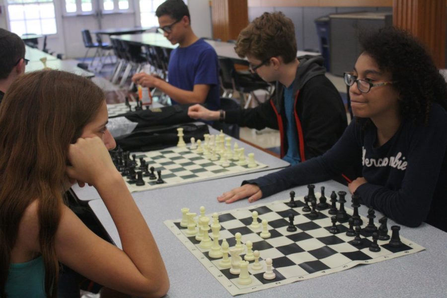 Freshman+Sophie+Kras+and+Katie+Eisenman+begin+a+game+of+chess.+Eisenman+plays+board+four+for+the+competition+team.+