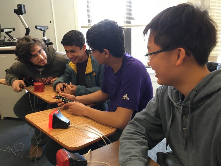 Juniors Moses Schindler, Raj Paul and Akshay Govindan and freshman Eric Yin confer about a question. 