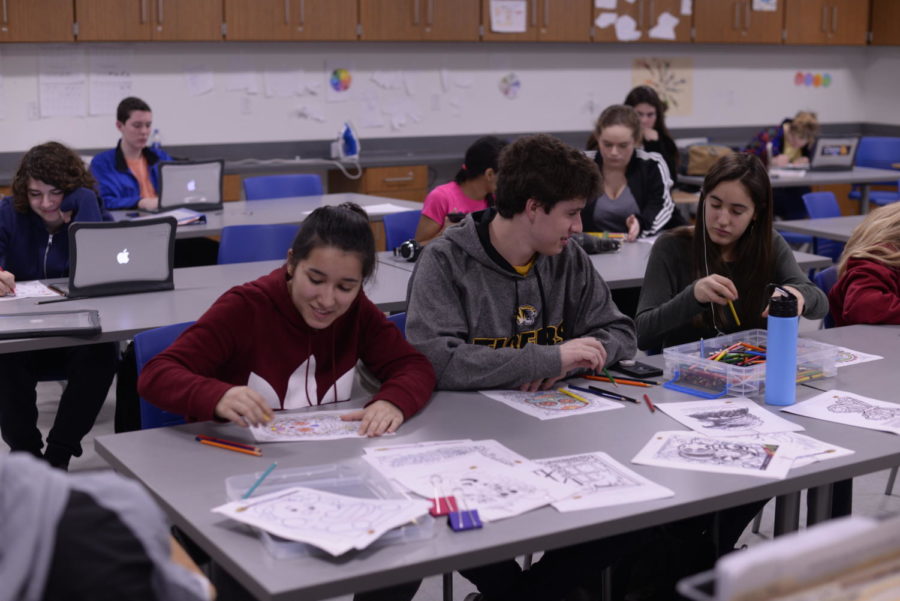 (From left to right) Senior Maria Orsay colors alongside sophomore Tyler Durbin and freshman Rebecca Orsay as one of De-Stress Day's five activities. De-Stress Day was organized by the De-Stress and Wellness Club which meets every other Wednesday after school in room 2402 or 2156. "I just like the activities," co-founder and junior Connie Chen said. "I really like having the variety of activities that people can choose from. And I think it's a fun experience for people."