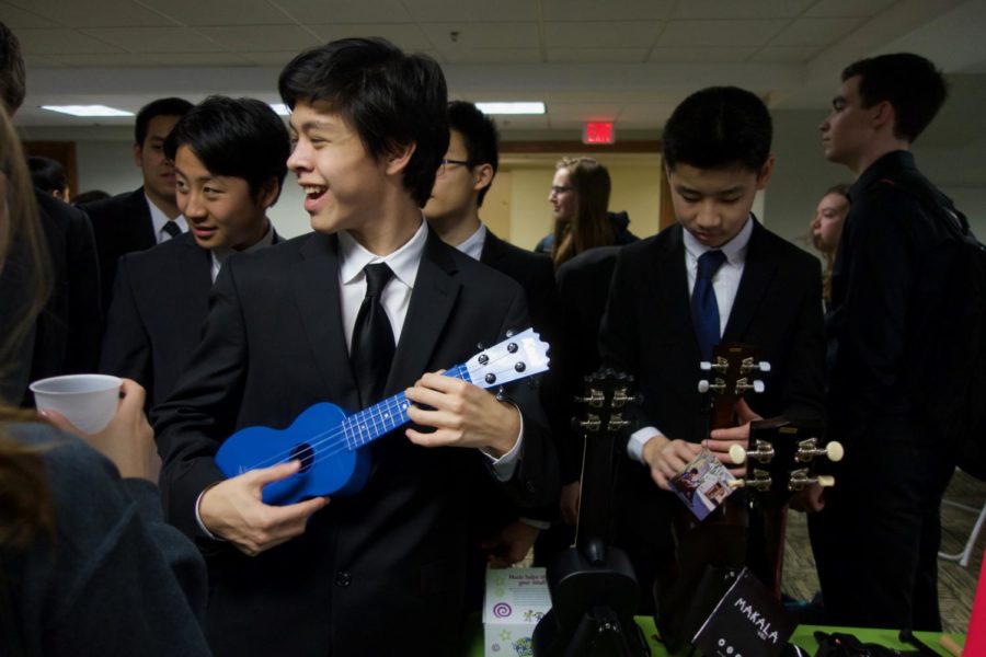 Junior and cellist Michael Wayne celebrates a successful performance at the Missouri Music Educators Association Jan. 25 by playing a ukulele. In Wayne’s spare time he enjoys playing the ukulele. After performing, band and orchestra members walked around to explore booths from music shops and different colleges.
