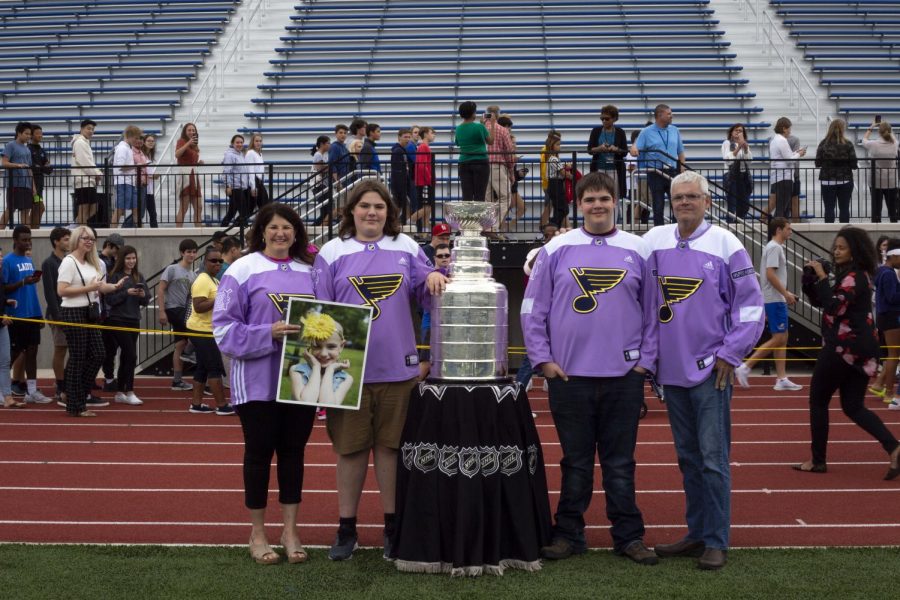 The Dougan family poses with the Stanley Cup on Ladue High Schools football field Oct. 3. The Stanley Cup was brought to Ladue as a surprise for the Dougans to honor their sister, Ari Dougan, who passed away nearly two years ago. 