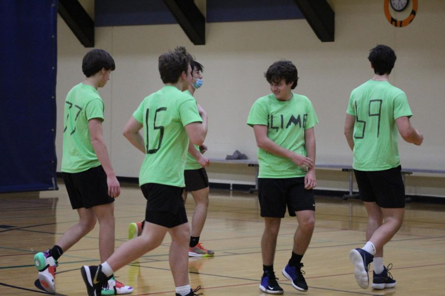 From left to right, Chase Linden, Noah Mitchell, Jimmy Gu, Grant Minkler and Will Moore gather around on the court. 