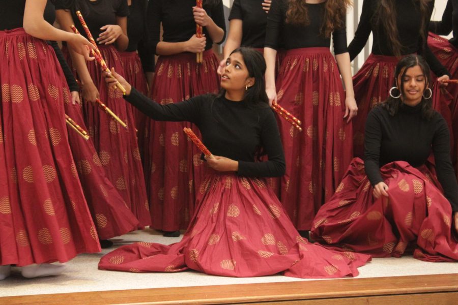 Gududuri sits on the ground, preparing for a photo after the performance