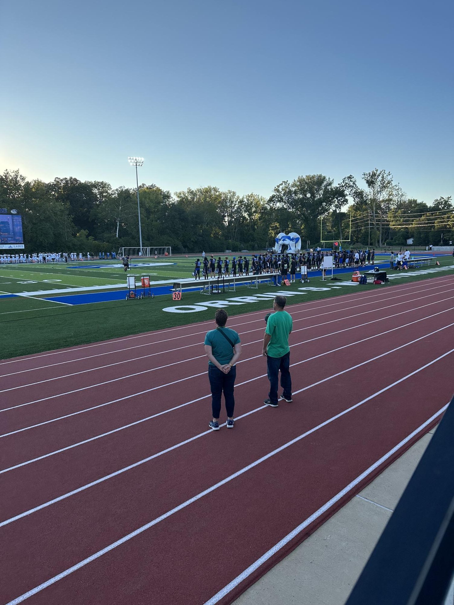 The football team stands during the playing of the national anthem at Ladue Horton Watkins High School Sept. 9. The team ultimately beat the Lindbergh Flyers 17-7. “The touchdown on the 10 yard line, when Beau threw it, [was my favorite moment of the night],” Bailey said. 