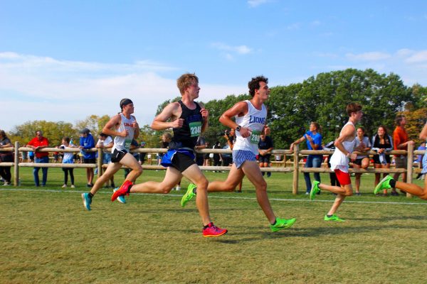 Caden Wheeler (11) nears the finish line of the varsity boys race.