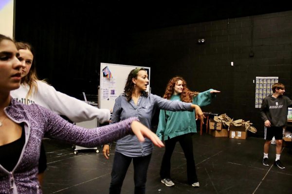 Jessica Winingham conducts a group shake-out amongst the “Puffs” cast and crew. Winingham always made sure to begin rehearsals with some form of exercise. “Warm-ups are essential for the cast and crew in order for them to prepare their minds and bodies for rehearsal,” Winingham said. “It also serves as [a] transition from school into the sacred space of rehearsal.” 
