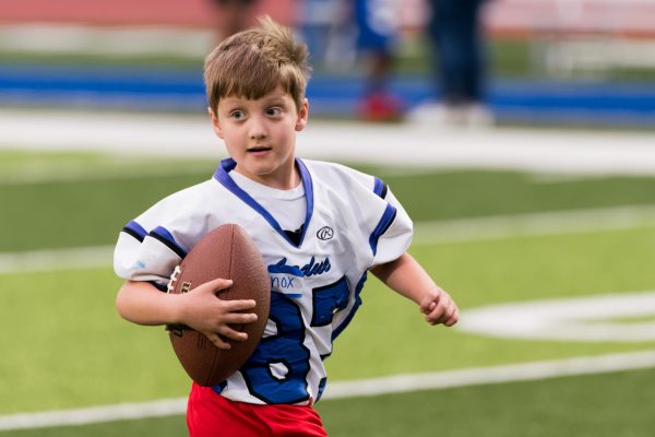 Knox Kennedy runs up the field
with a football. This was Kennedy’s third
year participating. “It’s an amazing night,”
business teacher Jessica Kennedy, Knox’s
mother, said. ”It is so heartwarming to
see students of all needs come together
for a unified community event.”