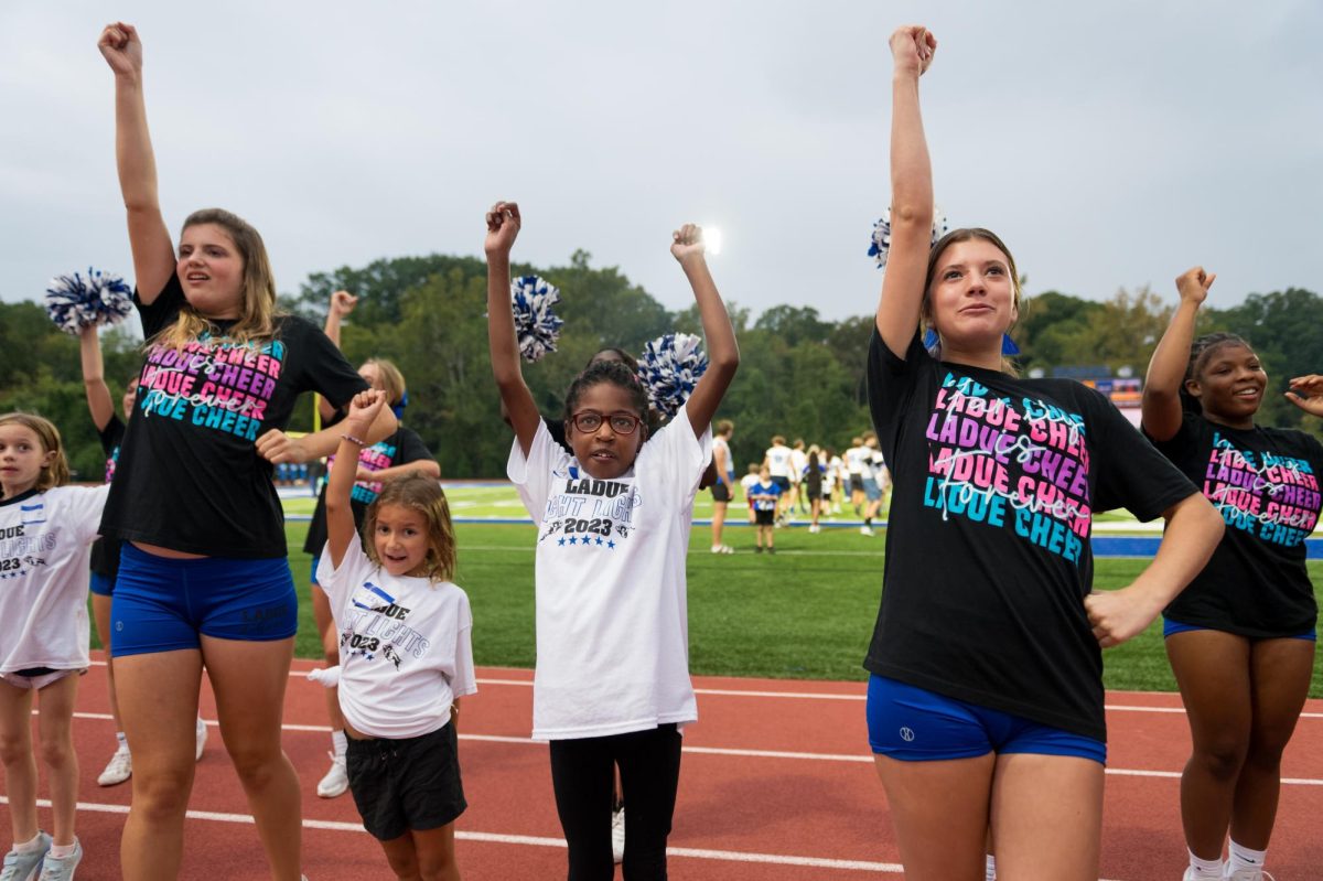 Amalia Frixone (9) and Bianca
Marbarger (11) call out a cheer with their
buddy Ayanna Ficklin. Ladue cheer
partnered with Ladue Night Lights
to teach their cheers to the buddies.
(Photos by Vincent Hsiao)