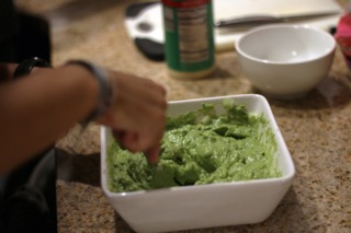 Junior Alexandra Tsygankov mashes up avocados for her moms famous guacamole recipe. Tsygankov mixed up the ingredients in order to make the guacamole, with a recipe she has been using for years. Its my mothers recipe, Ive been making it since I was little, Tsygankov said.