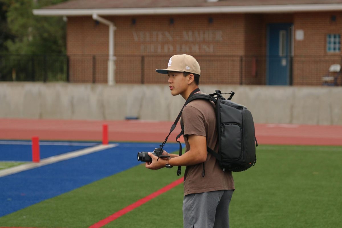  Junior Stephen Song films a video for Ladue’s varsity football team. Hes been filming for about two years. He started filming on his phone, but transitioned into a professional camera. He believes that anyone can start videography, or anything else they want to do. “Its less about your equipment but more about what you can do and maximizing with what you have,” Song said.