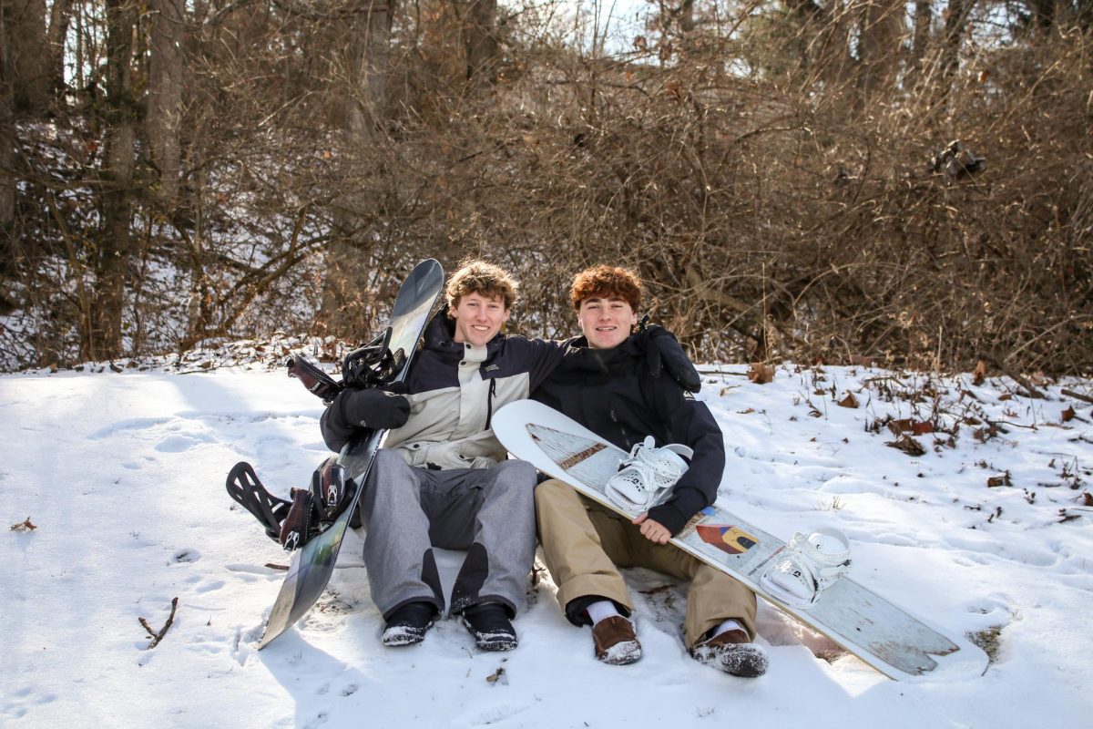Aidan and Liam Pippine sit down in their
backyard. They love to spend time outdoors
skiing, biking and snowboarding together. “Liam
and I like going off and doing our own things on
the mountain because we’re at a different skill
level than our parents,” Aidan said. (Photo by
Lathan Levy)