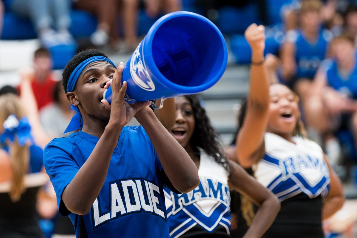 Junior Isak Taylor performs a chant during the fall sports pep rally. Taylor made the varsity squad after trying out April 2023. “Cheering is such an adrenaline rush,” Taylor said. “We’re always really excited because thats what gets the crowd pumped up. I feel like you cant even describe it unless youre there.”