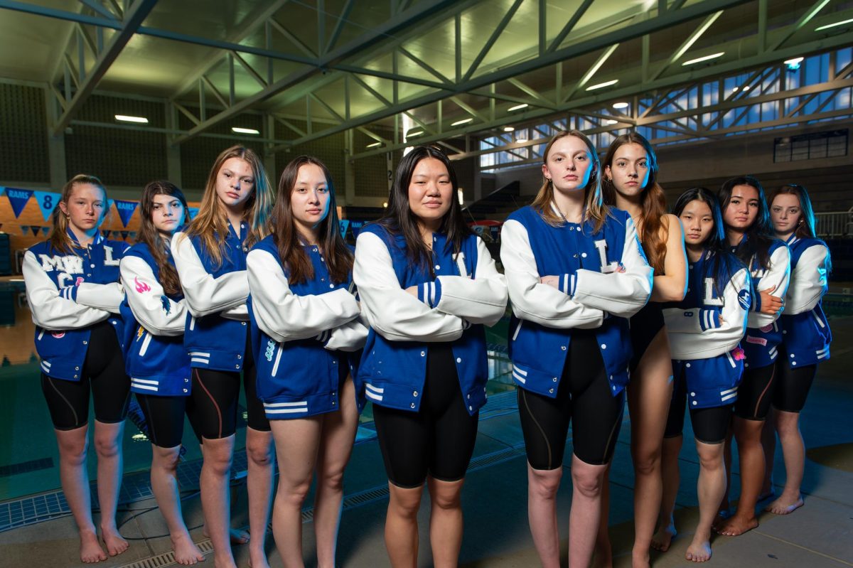 The 2024 girls state team of Meg Willmann (11), Francesca Bochicchio (12), Avery Warwick (9), Anna Dalton (12), Lily Hsieh (12), MJ Bezzant (12), Emily Dieckhaus (12), Phoebe Chen (12), Lily Ta (11) and Mia Singer (9) stand for a portrait in the pool Feb. 14. The team had swimmers qualified in eight of the 11 swimming events at the championship. “I’m really thankful that we get to play music during practice and laugh and smile and race together,” Ta said.