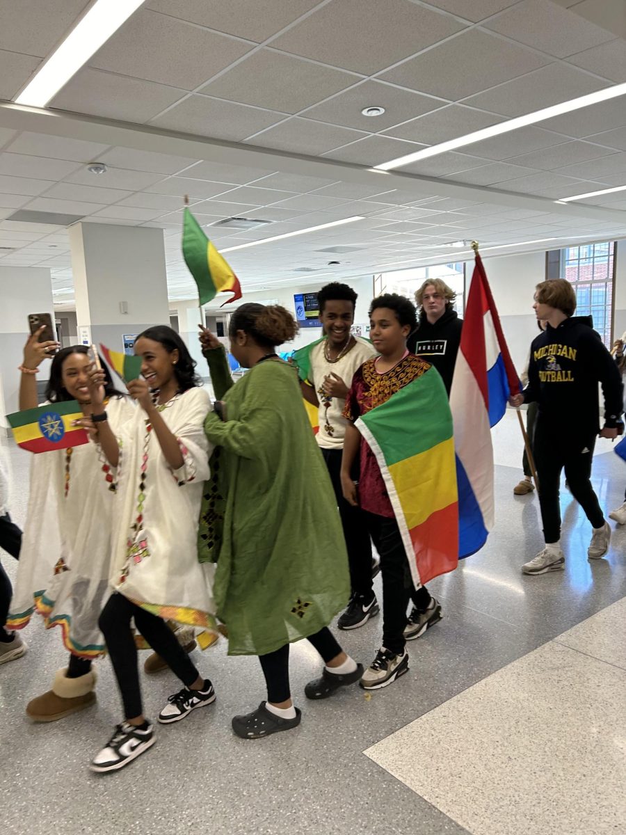 Students wave flags of countries that represent their cultural heritage during the Parade of Nations on Feb. 5. Students celebrated the tenth annual Parade of Nations by displaying important elements of their culture to represent how unique each individual Ladue student is. “Through the parade, students can gain an understanding of people they don’t usually talk to and who they are and what they represent,” Esayas said.
