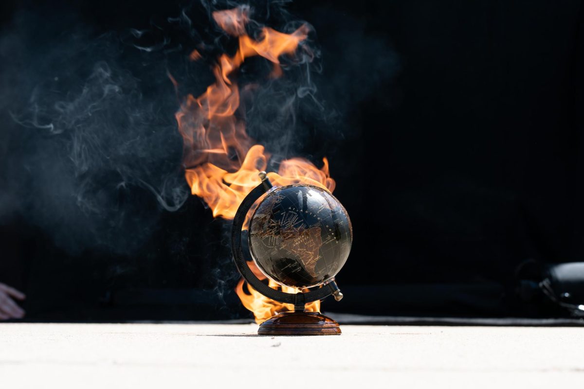 A globe on fire, symbolizing climate changes effects.