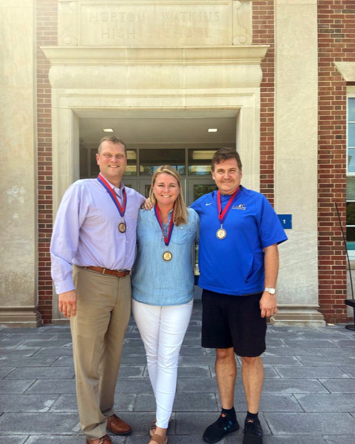 Brad Griffith, Riley Keltner, and Christopher Saxton stand with their medals. Each teacher was awarded the James Madison Fellowship.