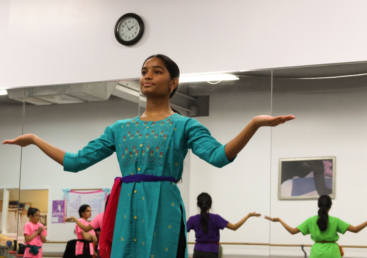 Sophomore Sahasra Mandalapu practices bharatanatyam choreography in class. These new dances will be performed in an annual show in February. Mandalapu found that practicing in class helped her overcome stage fright during her performances. “When [I] get on stage, I'm nervous I'm going to forget, even though I've done it for so long,” Mandalapu said. “There's still that little bit of stage fright [when] I second-guess myself that I don't know it enough, but I do because I've been practicing for a whole year.”