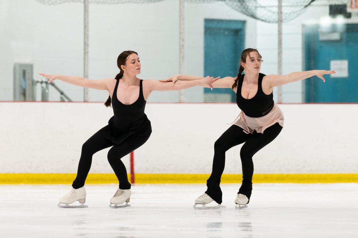 Sophie Miller (12) and Claire Malone (12) interlock their arms as they glide over the ice. Miller and Malone showed have been skating together for years. “Ive been skating with her [Malone] since I moved here,” Miller said. 
