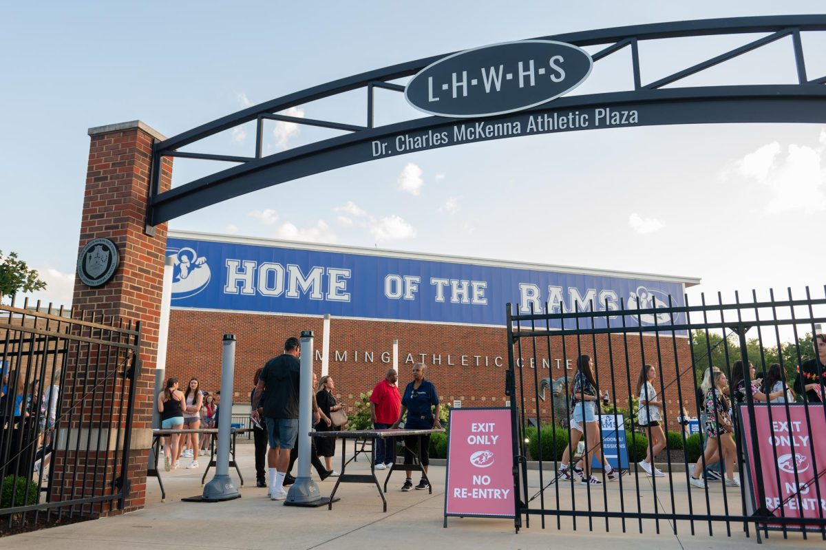 Attendees walk through metal detectors to enter the opening home varsity football game versus Ritenour High School, Friday, Sept. 6. It was the first event where security gates were implemented. “I felt like it was an airport,” Anastasia Chostner (12) said. “There were metal detectors and a much greater amount of cops.” 