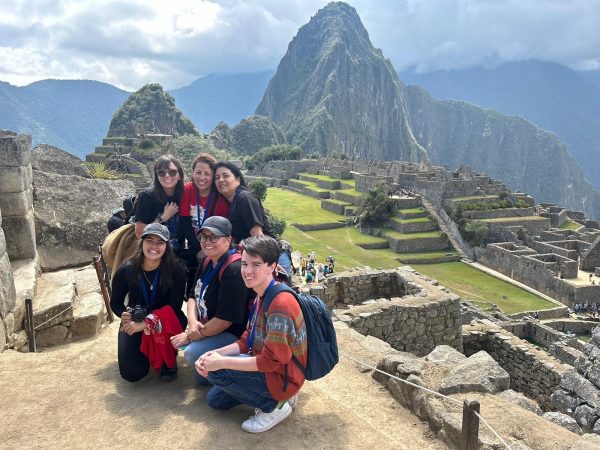 Art teacher Patricia Chavez and her family sit atop Machu Picchu. In order to secure a spot on a guided tour, her cousin bought her and her family tickets months in advance. “[My] favorite part was actually getting there, finally seeing the ruins,” Chavez said. “It’s just so beautiful with all the mountains all around you. It was breathtaking.” (Photo courtesy of Patricia Chavez)