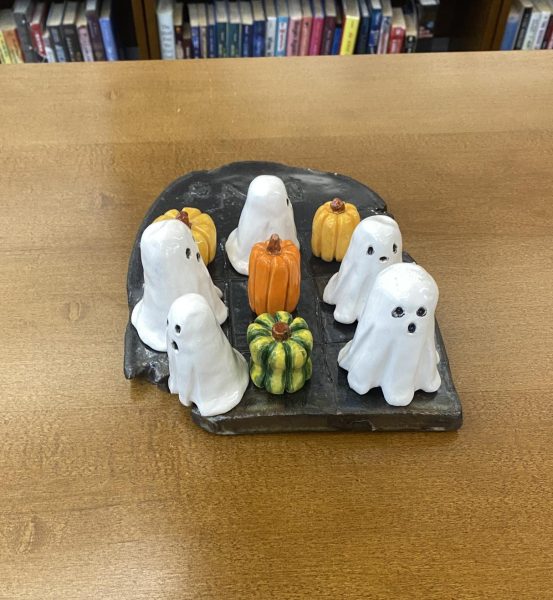 Art pieces from different level ceramics classes are displayed in the library. Students were given the task of making tic-tac-toe boards, with very little restrictions. "I'm really happy with the way my piece came out," Scotlynn Jones said. 