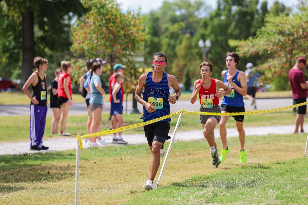 Will Laurine (9) runs during the Forest Park Cross Country Festival Sept.14. He placed 4th during the varsity white race. “We were trying to beat each other on the turn and [we] lost our footing,” Will said. “I was like, ‘I have to get up before him or he will beat me by a good amount.’ [I wanted to] finish the race, I’m not stopping [now].” Photo by Harper Buxner. (on page 24)
