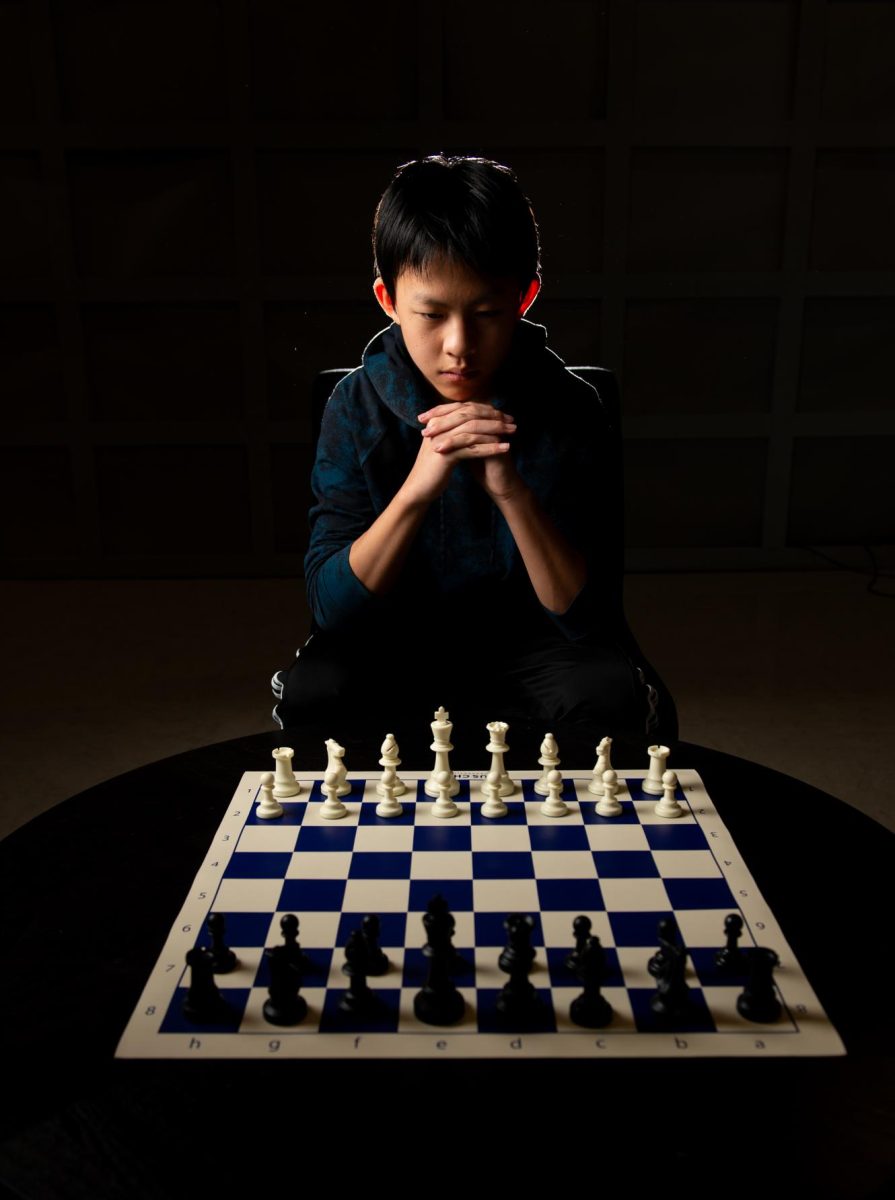 Alex Zhang (9) sits before a chess board, pondering his first move. He has beaten his friend, Huang, in speed chess five times in a row. “Once upon a time, I was higher rated than him,” Huang said. “It’s humbling to say that, but I’m also very proud of him, and very happy he’s managed to reach these levels of growth.”