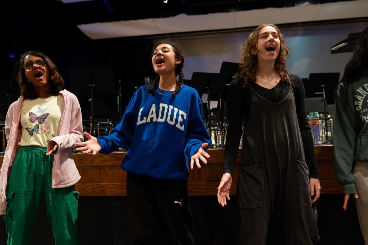 Norah Murphy (11) and Kayla Wallace (12) practice for their 2024 spring concert. They will perform in Viva Voce’s annual winter concert Dec. 14. “The group will sing our old songs and then we’ll also sing our competition set,” Murphy said.  