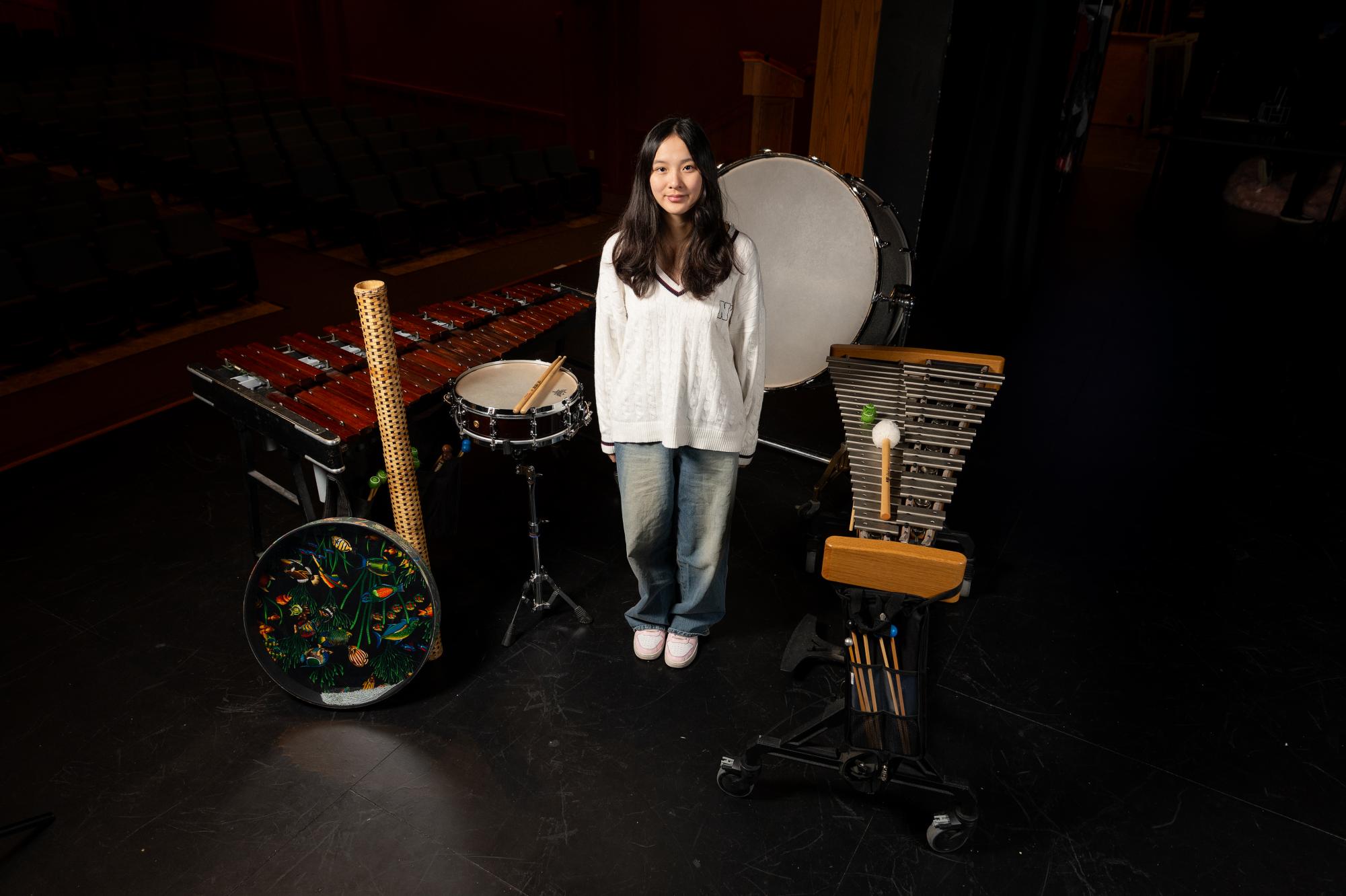 Kimmi Lin (11) stands alongside her instruments in the Ladue High School Performing Arts Center Dec. 3. Lin’s favorite artist is Laufey. “School and practice are separate. I don’t like school, I like percussion.”