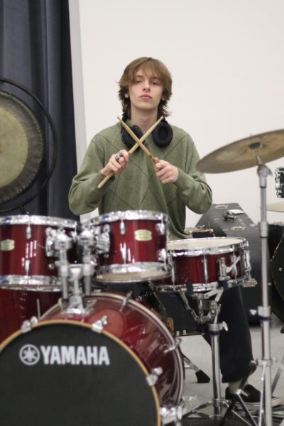 Silas Baltzell (10) plays the tuba, jazz guitar, electric guitar and drums in the band room. In addition, Baltzell has also been producing his own music for a year. Being immersed in music doubles as a form of therapy for Baltzell. “If I’m ever not having a good week, I can always listen to music [and] know that I’m not alone with whatever I’m going through,” Baltzell said. “Finding music that helps you feel identified and validated for what you’re going through really helps.”