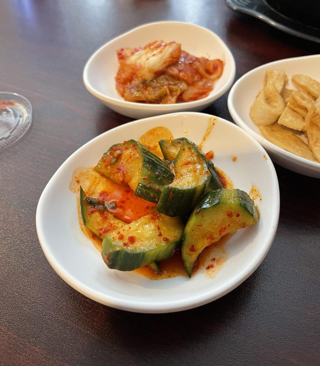 Spicy Cucumber Salad, or Oi Muchim, sits on the table.