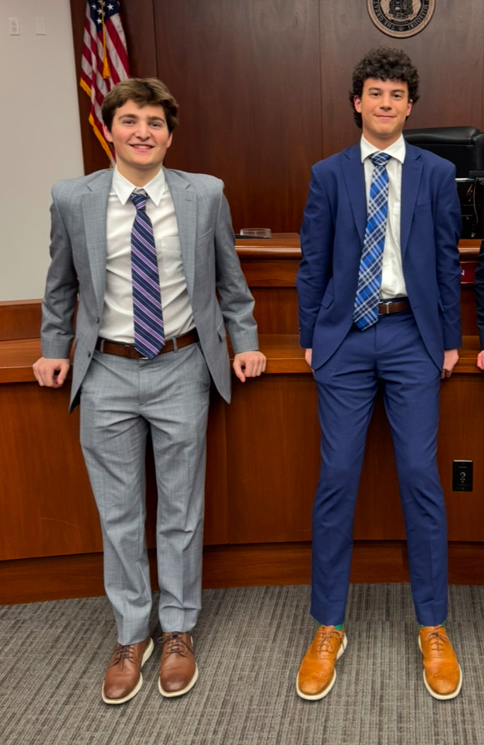 Jake Winograd and Hobey Alton stand in the courtroom after their first Mock Trial competition. Winograd joined the club this year and prepared for months for the big day. "I was super excited but a bit nervous for the first trial, we lost but it was a good learning experience," Winograd said. 